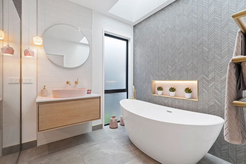 Luxurious Bathroom with grey chevron feature wall, Newtech timber vanity, Robertson's pink concrete basin