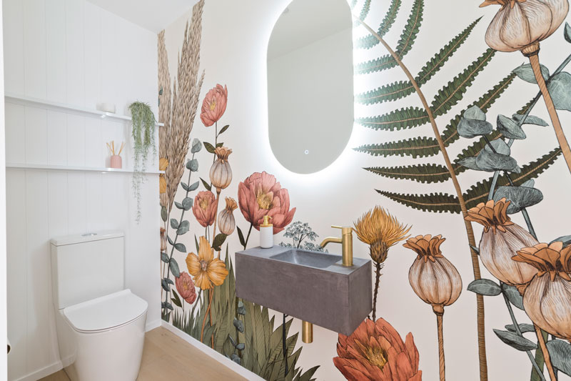 Gorgeous guest toilet with floral feature wallpaper, robertsons concrete basin in Paerata Rise showhome
