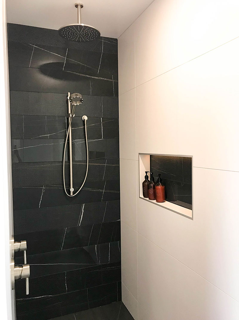 Tile Space Black Marble tiles at back of tiled walk in shower with recess box
