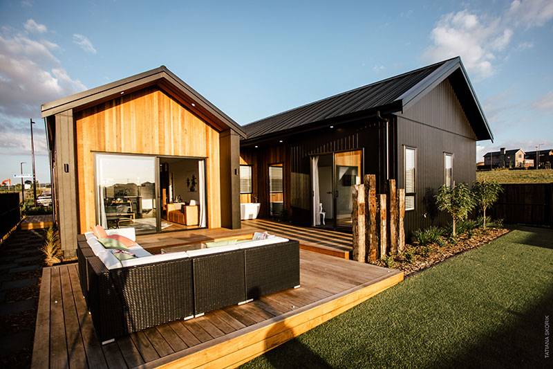 back deck of beauitful bespoke home clad in cedar and black axon panel