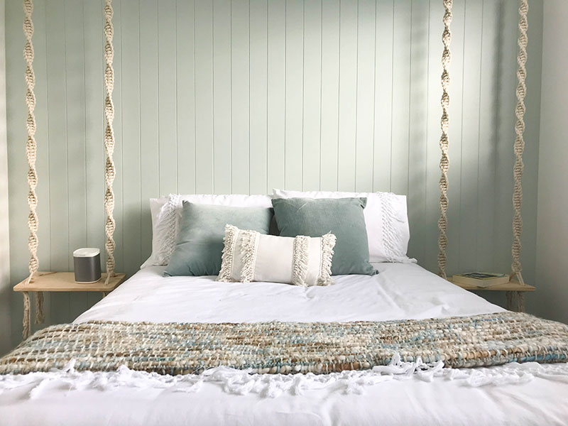Bedroom with mint duckegg feature wall with hardigroove. Rope swing side tables