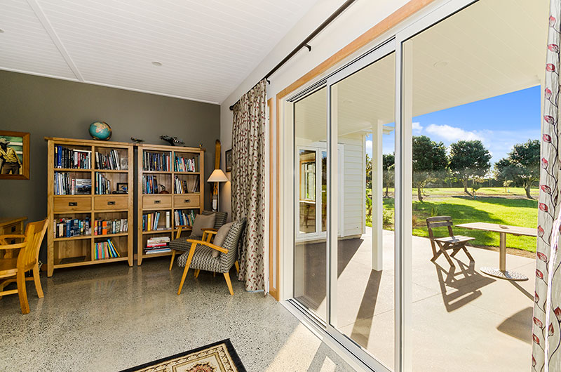 Study nook with polished concrete floor and outdoor area at Award winning colonial home in Waiau Pa