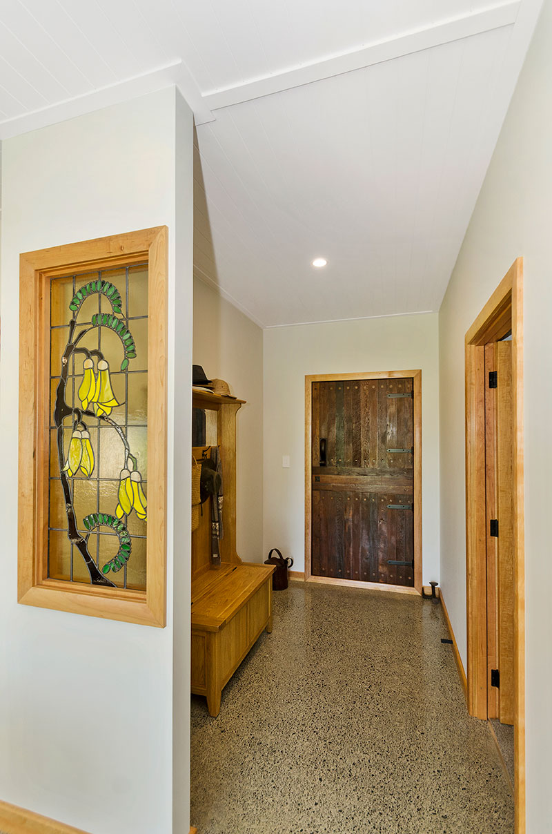 Stunning kowhai stained glass panel and chilean wood rustic entry door in award winning home