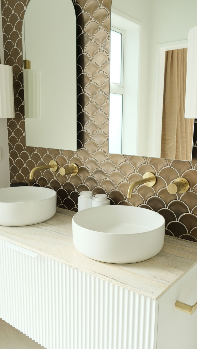 Gorgeous mediterranean/morrocan inspired bathroom with fluted vanity, white vessel basins, Precision Homes showhome