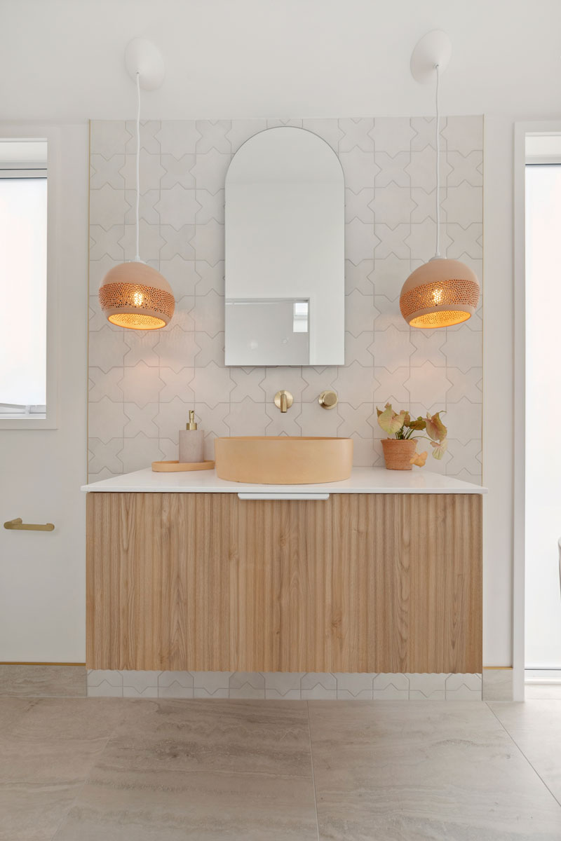 Gorgeous mediterranean/morrocan inspired bathroom with fluted timber vanity, terracotta Mr Ralph lights, Precision Homes showhome