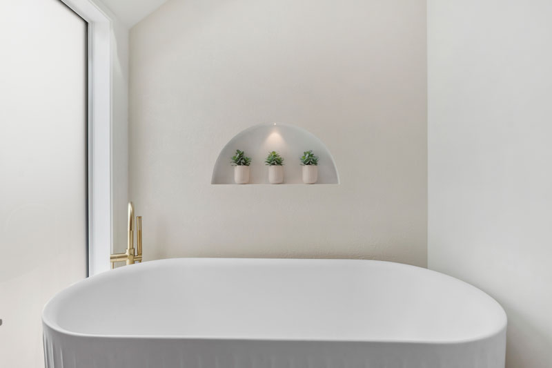 Gorgeous mediterranean/morrocan inspired bathroom with Pettine Bath, brass tapware, arched soap box, Precision Homes showhome