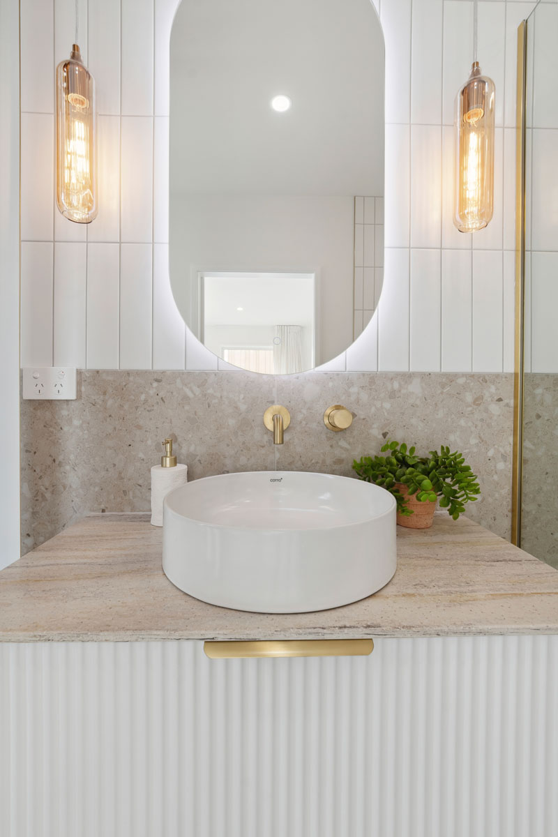 Gorgeous showhome bathroom with fluted vanity, Brass fittings, Tile Space Tiles, Social Light lights, Precision Homes showhome