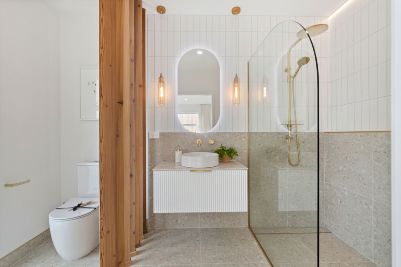 Gorgeous mediterranean inspired bathroom with fluted vanity, cedar divider, Precision Homes showhome