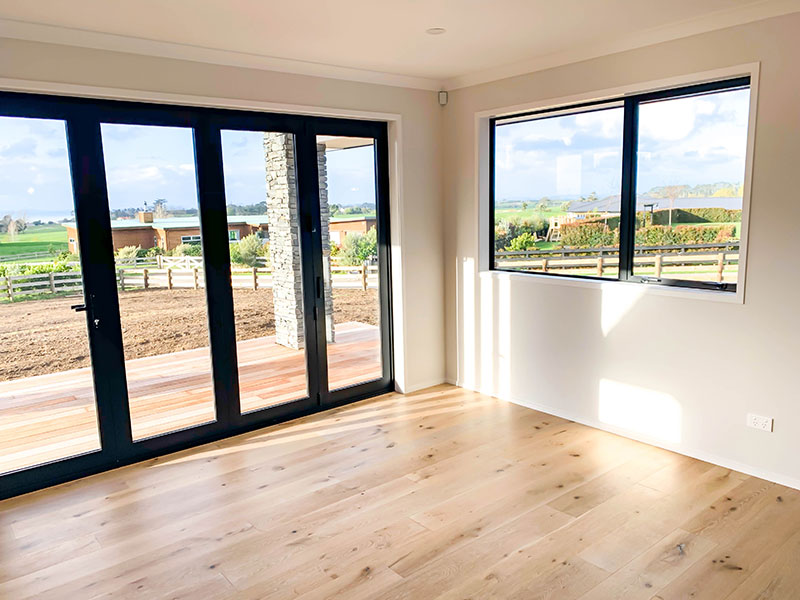 Beautiful Hurford French Oak Timber Floor in open plan living space with black french doors