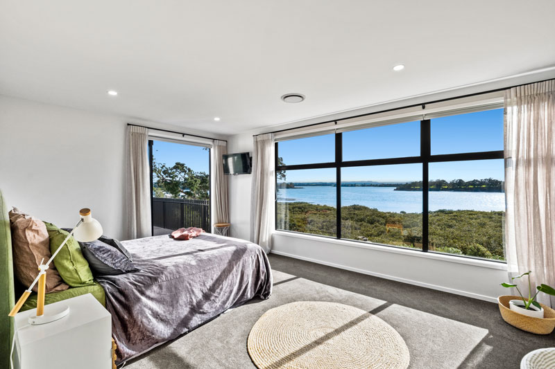 masterbedroom in designer home with beauitful harbour view and large windows