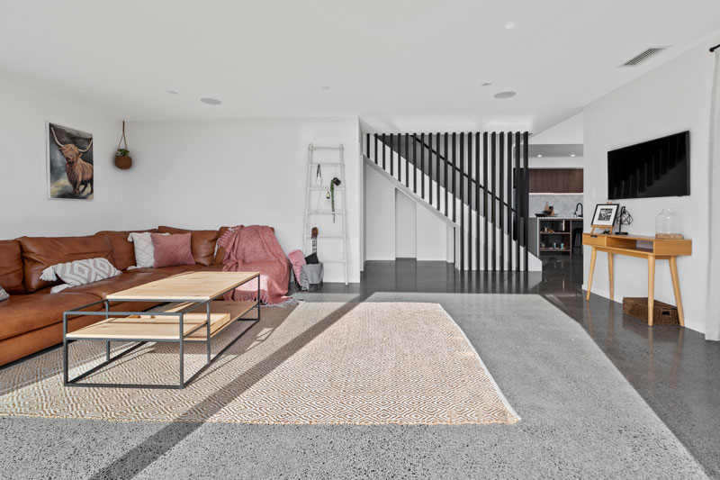open living space with polished concrete floors, black timber linear balustrade in designer home in Franklin 