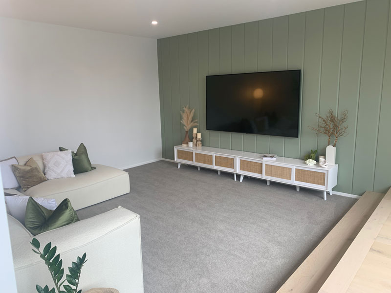 Paerata Rise Showhome large sunken lounge with green feature wall in James Hardie Oblique 