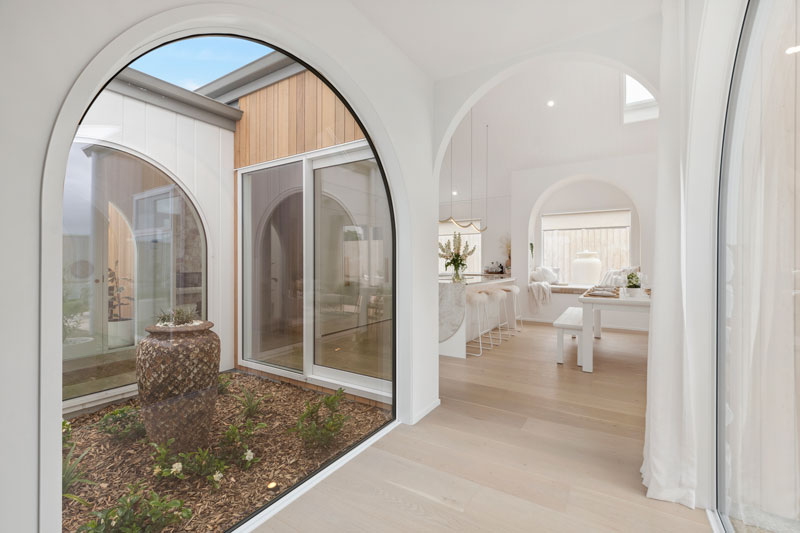 Gorgeous Med inspired home with arched windows and hallways, window seat, Precision homes showhome