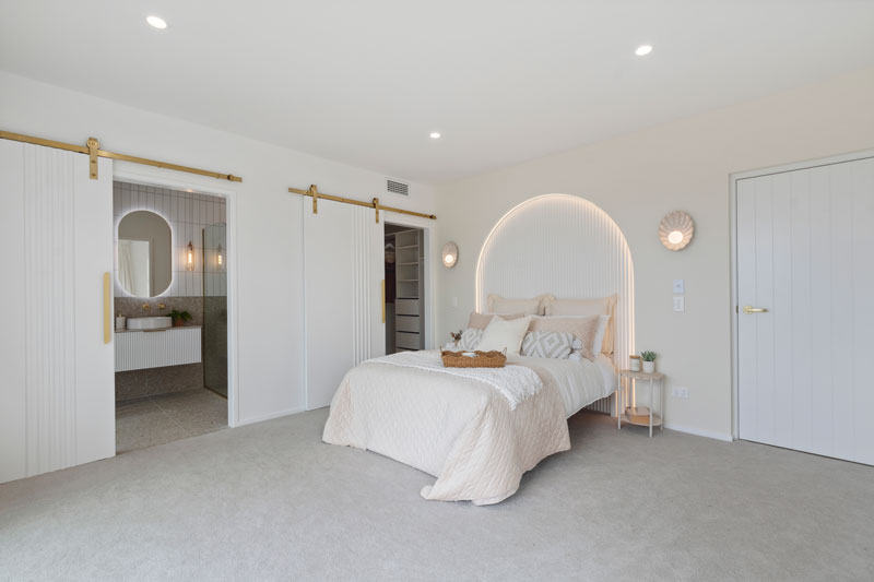 Gorgeous Med inspired home with arched panelled feature wall behind bed, Precision homes showhome