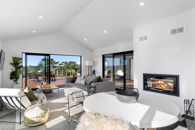 stunning living space with fireplace and concrete polished floors in award winning home