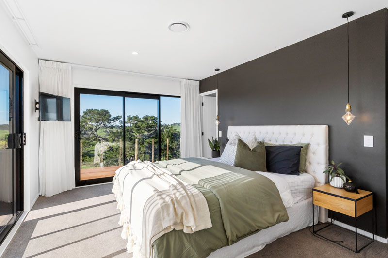 beautiful master bedroom with charcoal feature wall and feature lighting in award winning Franklin home