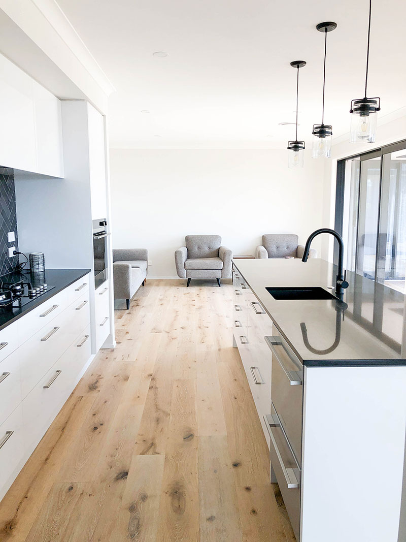 Black and white kitchen with Hurford French Oak White wash timber floor and pendent lights