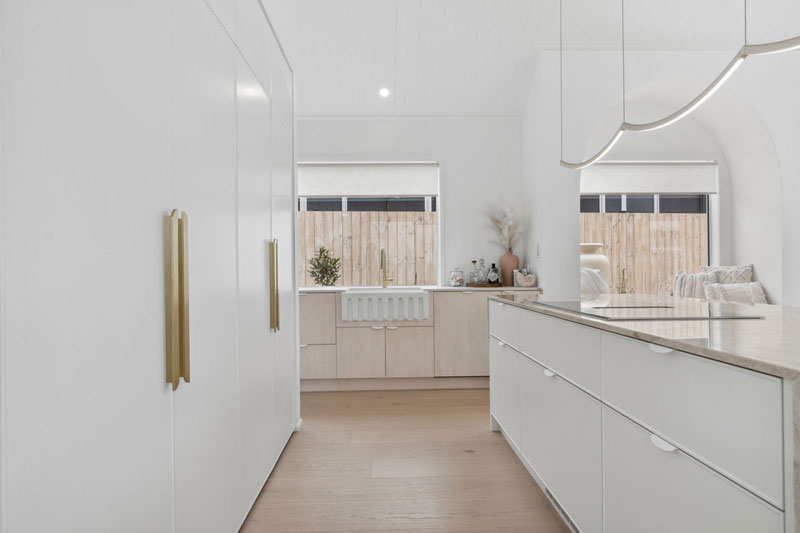 Gorgeous light timber and white kitchen with brass fittings, butlers sink, granite benchtop, Paerata Rise showhome