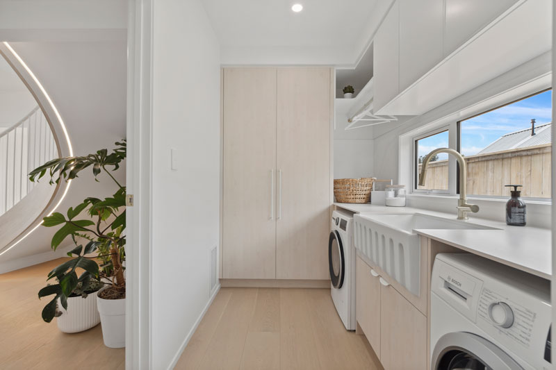 stunning timber and white laundry with butlers sink and laundry chute in 38 Te Rata Boulevard Paerata Rise, precision homes showhome