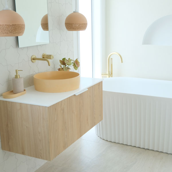 Precision Homes Showhome bathroom with Pettine Robertson Bath, Bare Concrete Orange Vessel Basin, timber fluted vanity